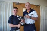 Antrim Football Manager Liam Bradley presenting James with his trophy