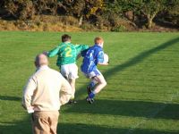 Caolan gets tight to put in a tackle