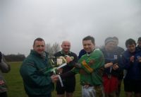 The experienced captain and man of the match accepts the trophy for the winning Creggan team.